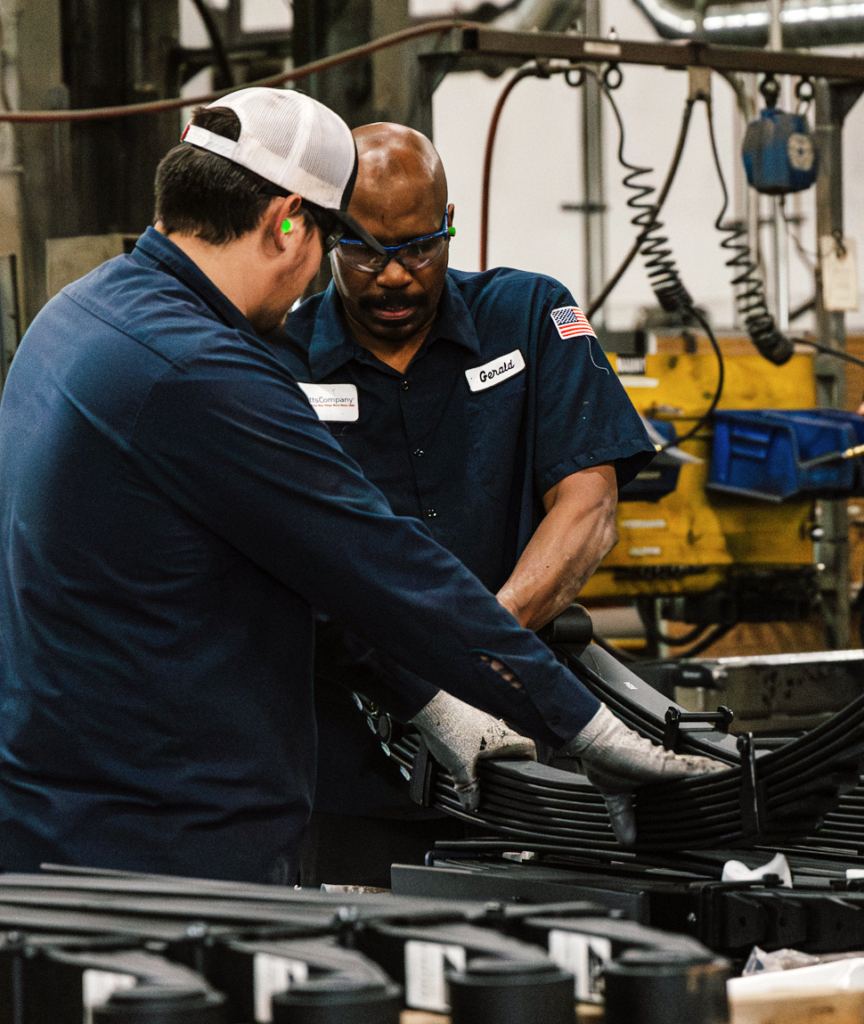 two male workers at a factory